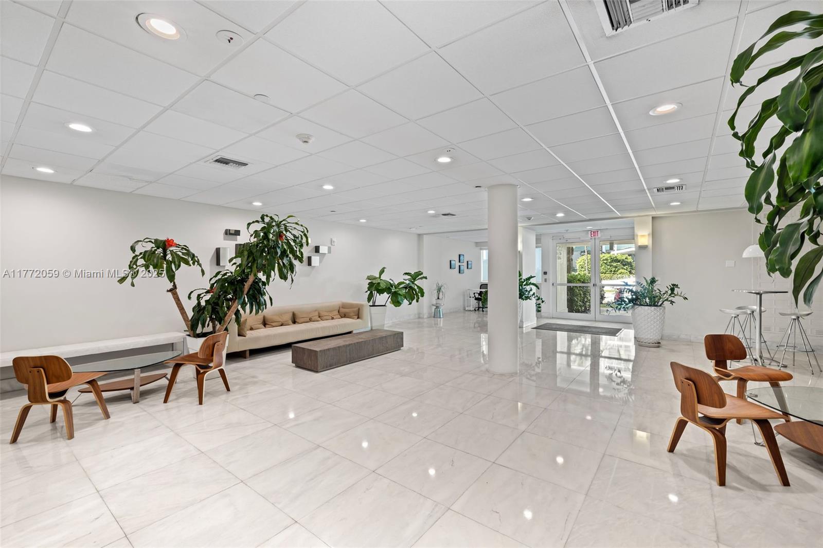 1035 West Avenue, Unit 507 Miami Beach, FL 33139 - Photo 12 of 22 a living room with furniture a potted plant and a rug