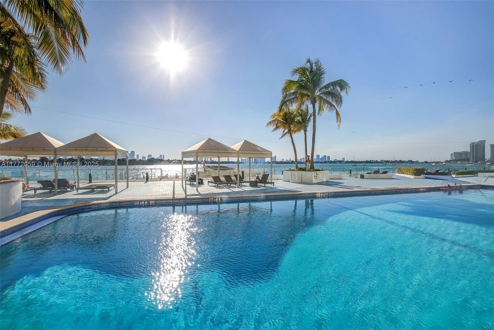 1035 West Avenue, Unit 507 Miami Beach, FL 33139 - Photo 17 of 22 a view of swimming pool with outdoor seating and lake view