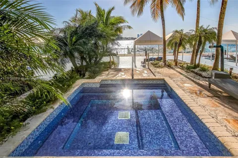 a view of a backyard patio and swimming pool