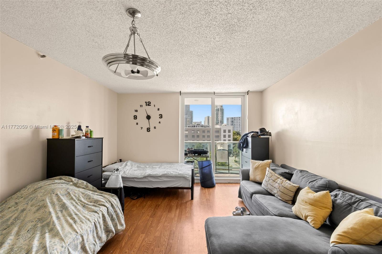 1035 West Avenue, Unit 507 Miami Beach, FL 33139 - Photo 6 of 22 a bedroom with furniture and wooden floor