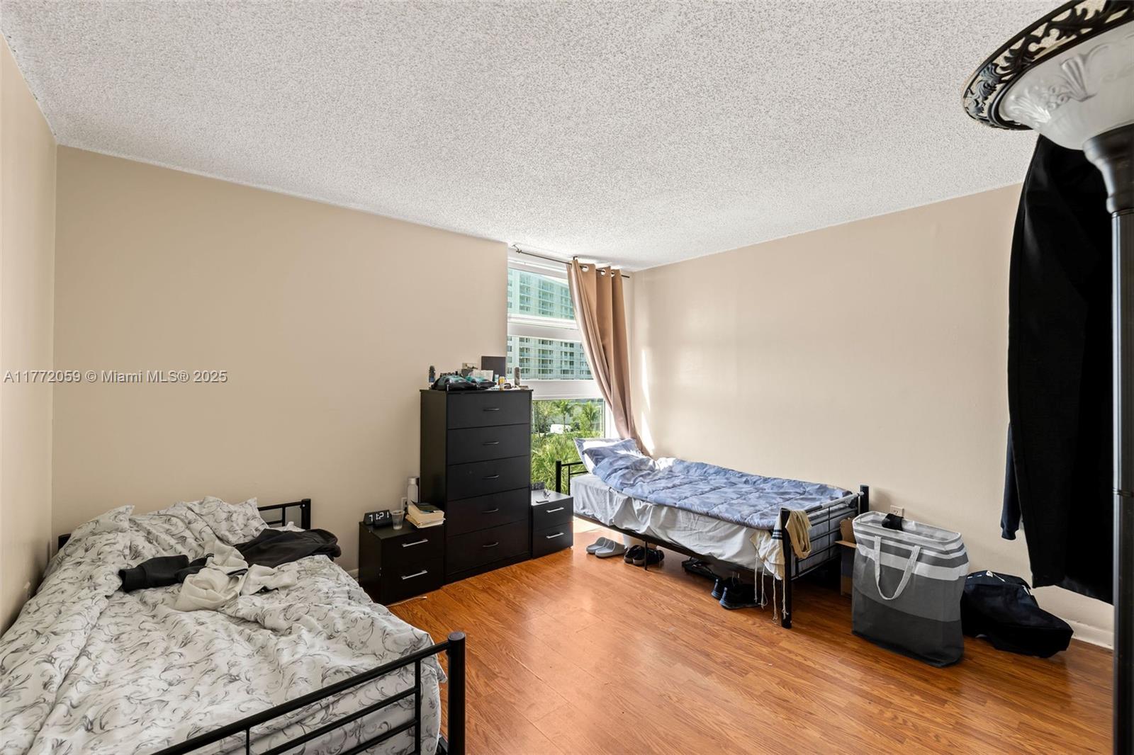 1035 West Avenue, Unit 507 Miami Beach, FL 33139 - Photo 7 of 22 a bedroom with furniture and a window