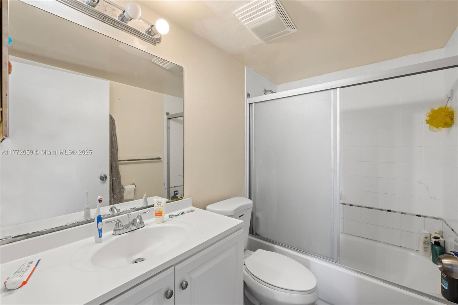 1035 West Avenue, Unit 507 Miami Beach, FL 33139 - Photo 8 of 22 a bathroom with a sink toilet and shower