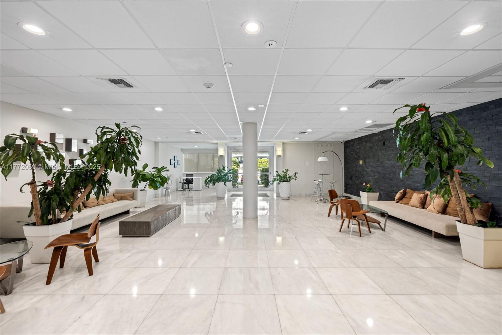 1035 West Avenue, Unit 507 Miami Beach, FL 33139 - Photo 10 of 22 a lobby with furniture and potted plants