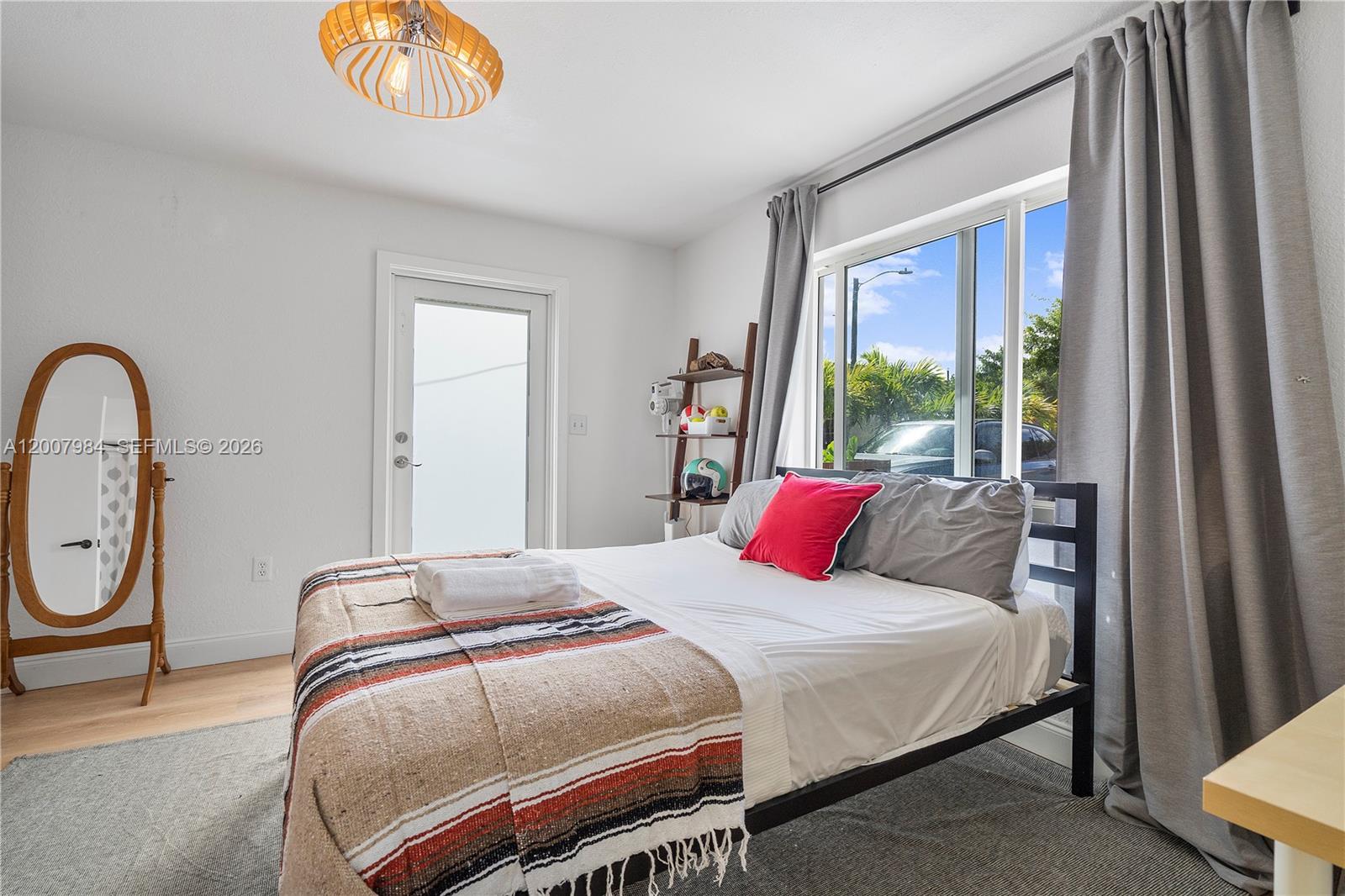 2380 Northeast 137th Street, Unit RIGHT North Miami Beach, FL 33181 - Photo 11 of 23 a bedroom with a bed a closet and a large window
