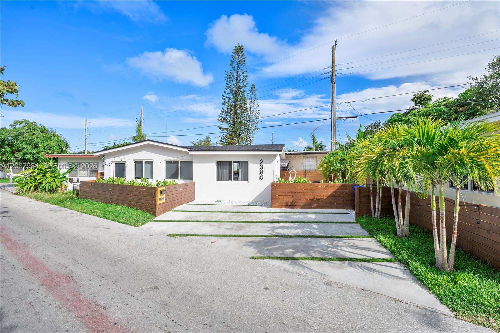 2380 Northeast 137th Street, Unit RIGHT North Miami Beach, FL 33181 - Photo 13 of 23 a front view of a house with a yard