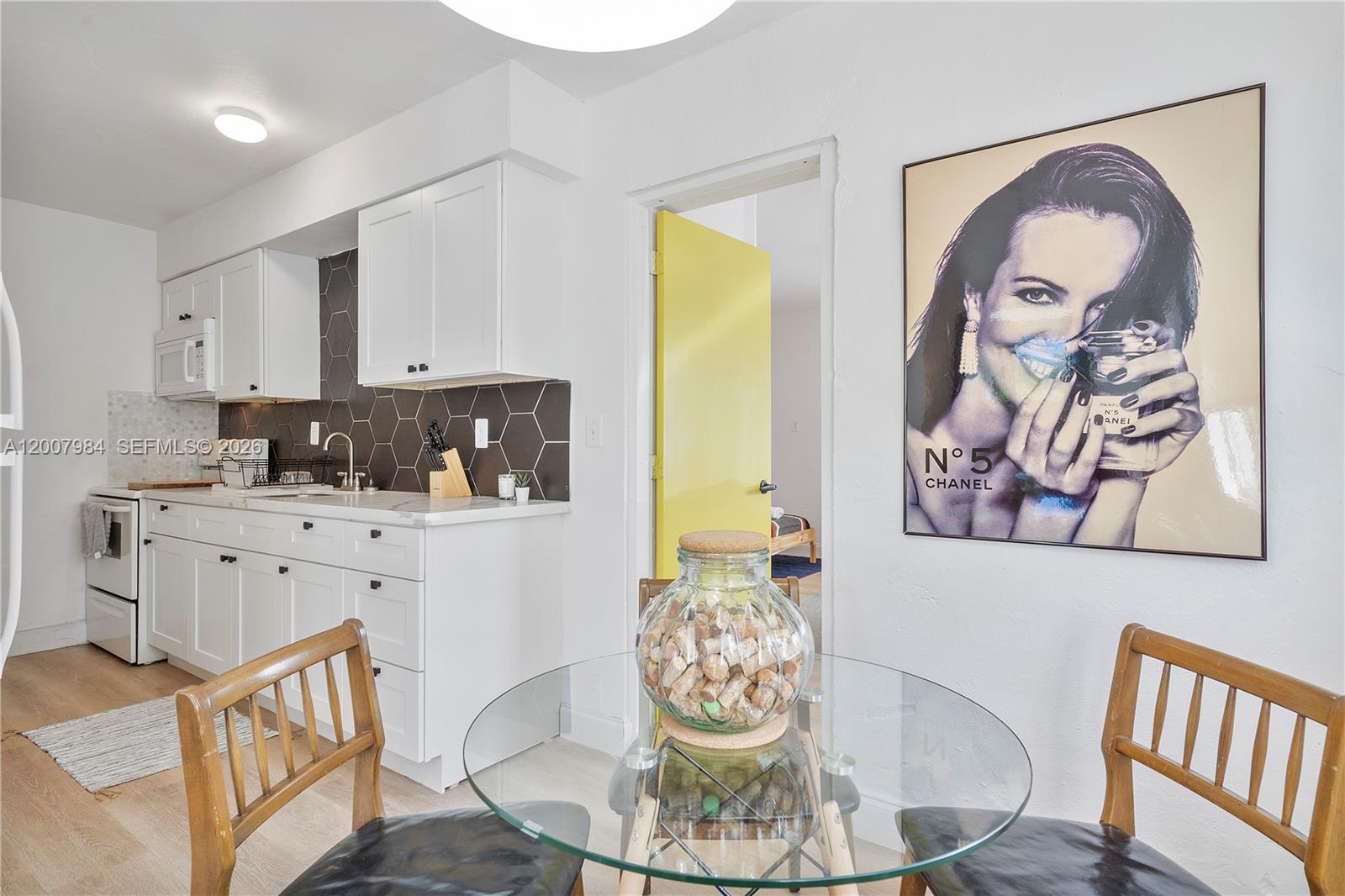 2380 Northeast 137th Street, Unit RIGHT North Miami Beach, FL 33181 - Photo 15 of 23 a kitchen with a table and chairs