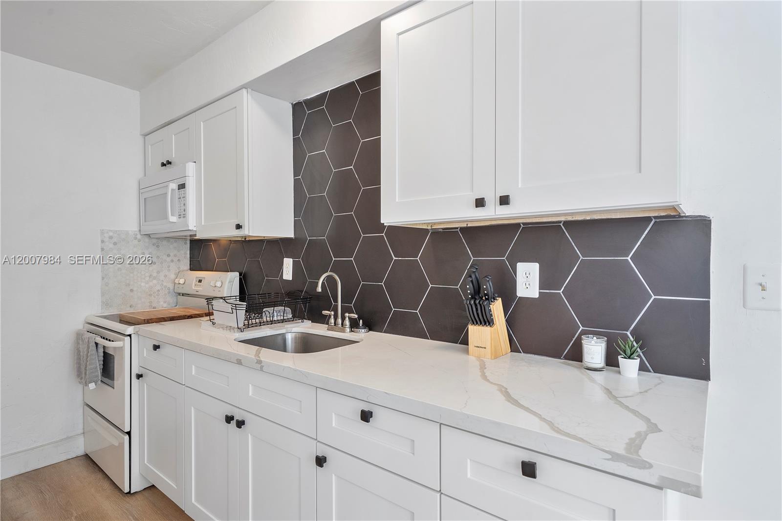 2380 Northeast 137th Street, Unit RIGHT North Miami Beach, FL 33181 - Photo 17 of 23 a kitchen with a sink and cabinets