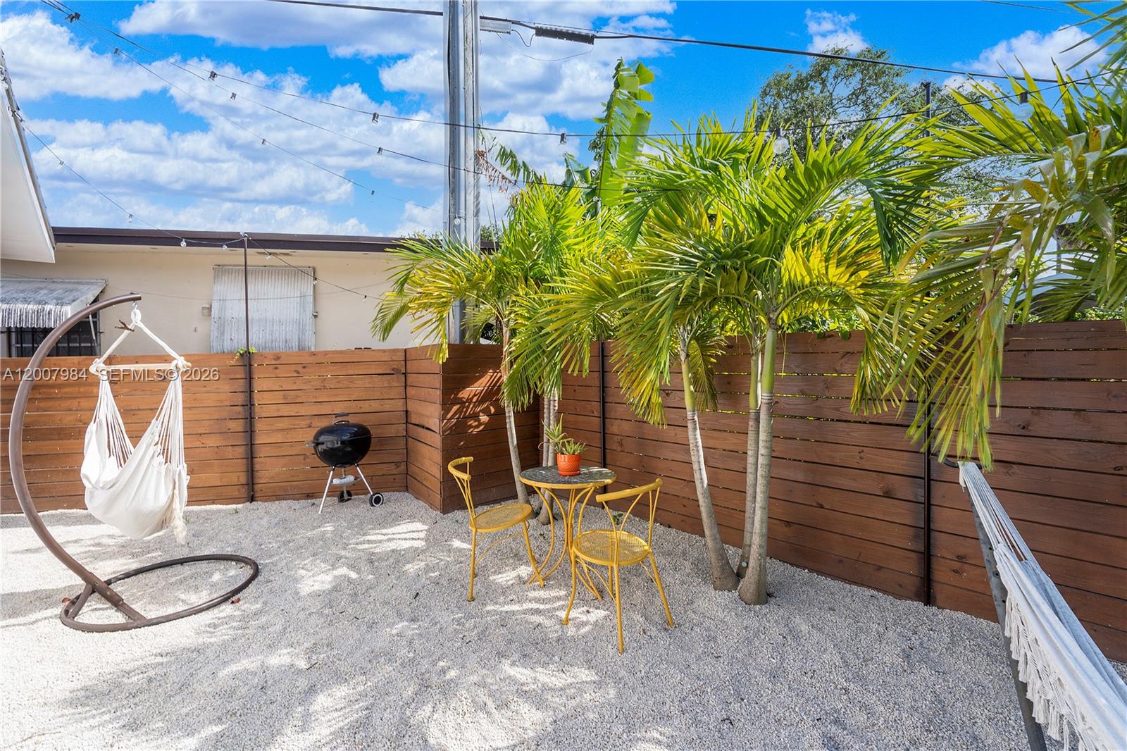 2380 Northeast 137th Street, Unit RIGHT North Miami Beach, FL 33181 - Photo 20 of 23 a view of a patio with table and chairs and potted plants