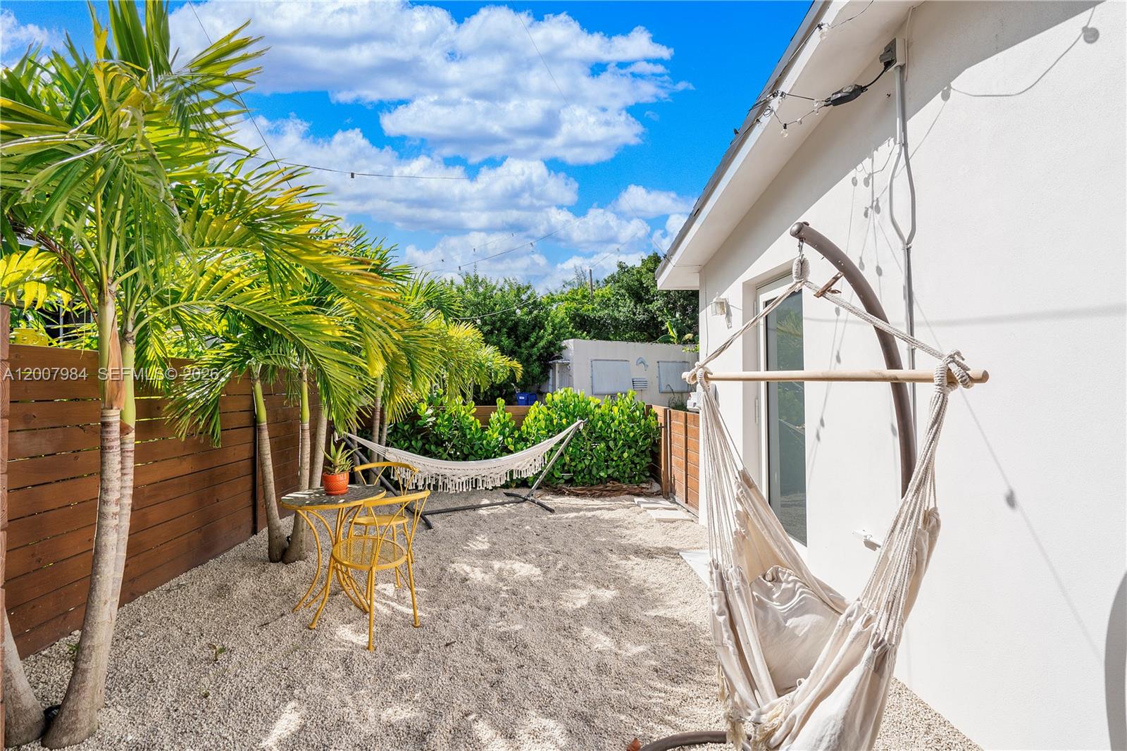 2380 Northeast 137th Street, Unit RIGHT North Miami Beach, FL 33181 - Photo 22 of 23 a view of a chair with potted plants in front of house