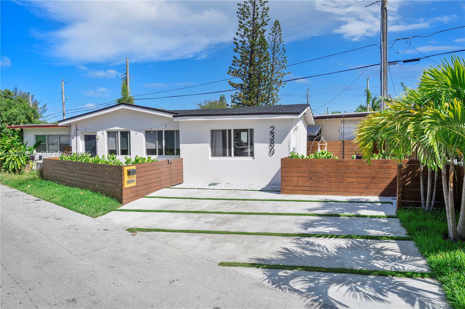 2380 Northeast 137th Street, Unit RIGHT North Miami Beach, FL 33181 - Photo 5 of 23 a front view of a house with a yard table and chairs