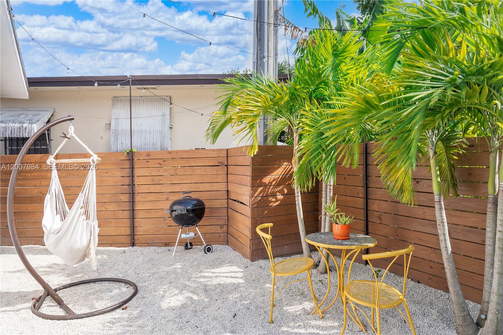 2380 Northeast 137th Street, Unit RIGHT North Miami Beach, FL 33181 - Photo 7 of 23 a blue table and chair sitting in a backyard