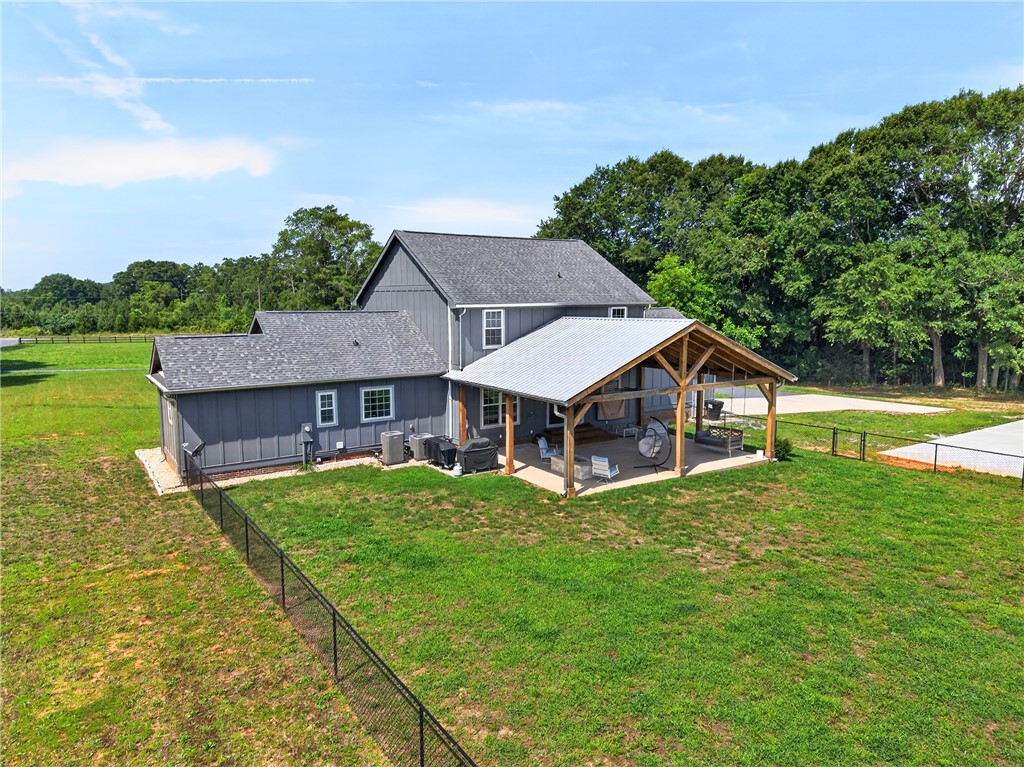 5016 Copeland Road Belton, SC 29627 - Photo 41 of 45 A spacious backyard features a generous covered patio for outdoor enjoyment.