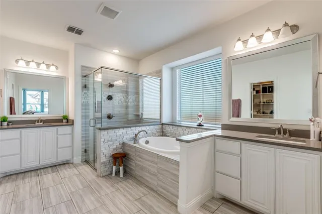 a bathroom with a sink a large mirror and a bathtub