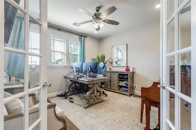 a living room with furniture a large window and a chandelier