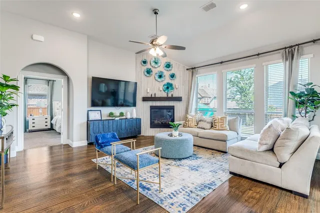 a living room with furniture a fireplace and a flat screen tv
