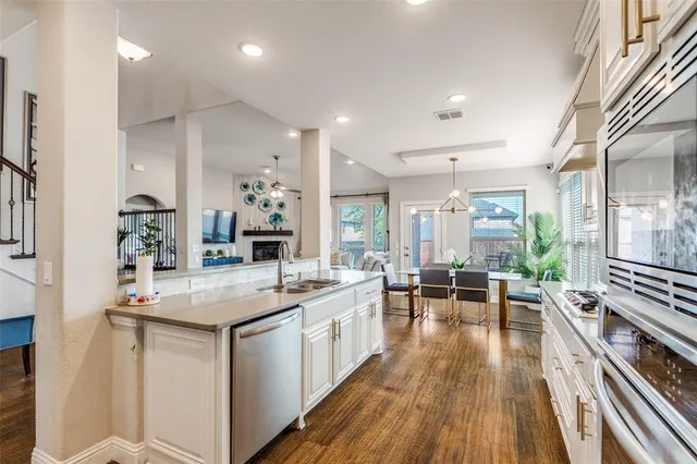 a kitchen with sink stove and chairs