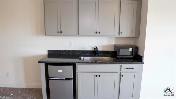 a kitchen with stainless steel appliances granite countertop a sink stove and cabinets