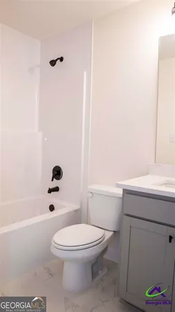 a bathroom with a toilet a sink and bathtub