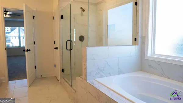 a bathroom with a bathtub and shower