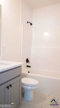 a bathroom with a toilet a sink and bathtub