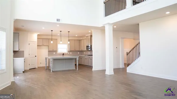 a view of kitchen with granite countertop cabinets and fireplace