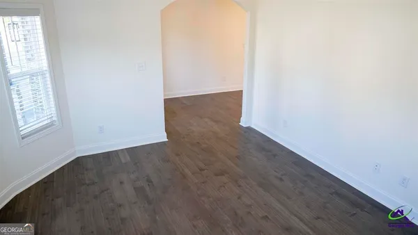 a view of an entryway with wooden floor and windows