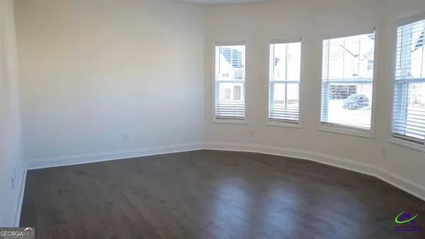 a view of an entryway with wooden floor