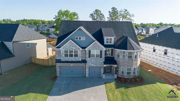 an aerial view of a house with a yard