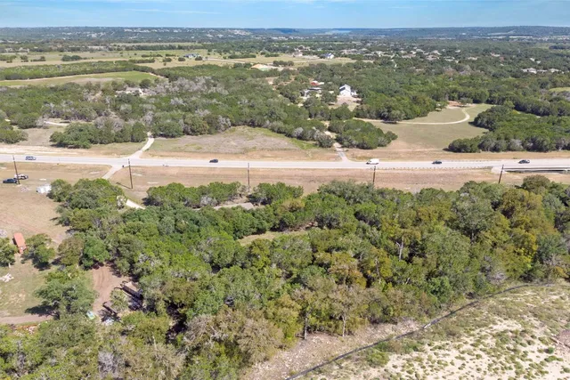 an aerial view of a houses with a yard