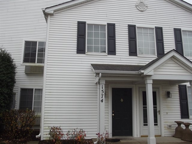 1574 McClure Road, Unit 1574 Aurora, IL 60505 - Photo 1 of 7 a view of a house with white door and a tree