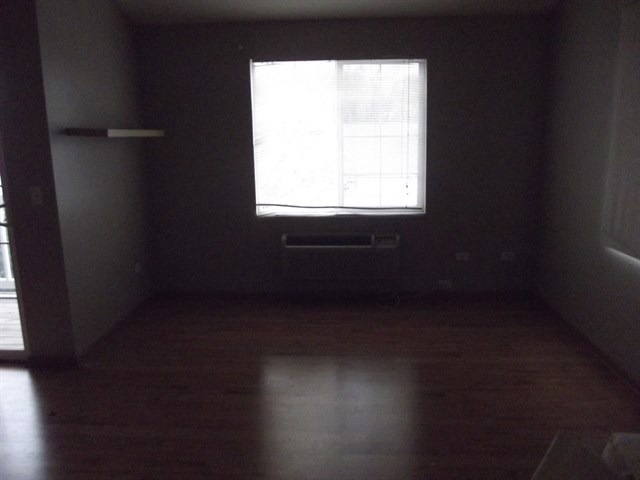 1574 McClure Road, Unit 1574 Aurora, IL 60505 - Photo 2 of 7 a view of a small space with wooden floor and a window