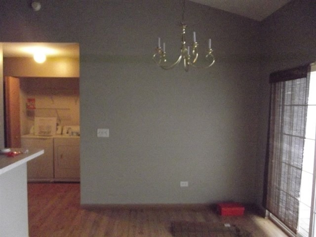 1574 McClure Road, Unit 1574 Aurora, IL 60505 - Photo 3 of 7 wooden floor in an empty room with a window