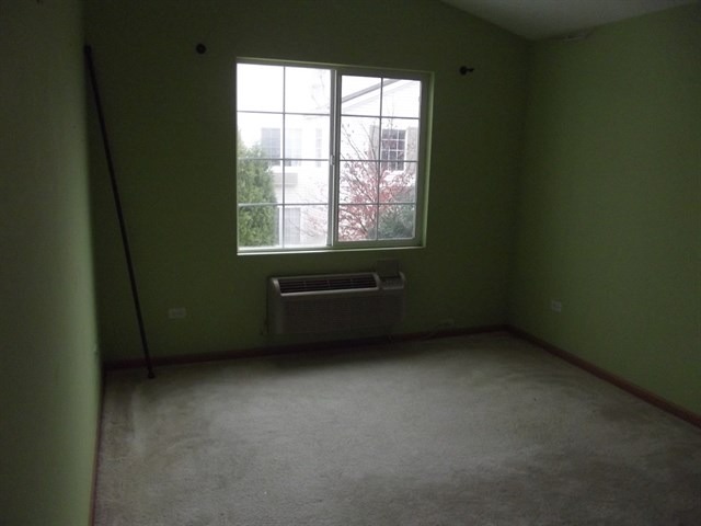 1574 McClure Road, Unit 1574 Aurora, IL 60505 - Photo 5 of 7 a view of an empty room with a window