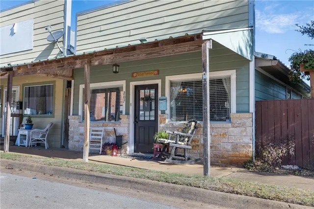 a front view of a house with outdoor seating