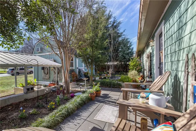 a view of a chairs and table in backyard of the house