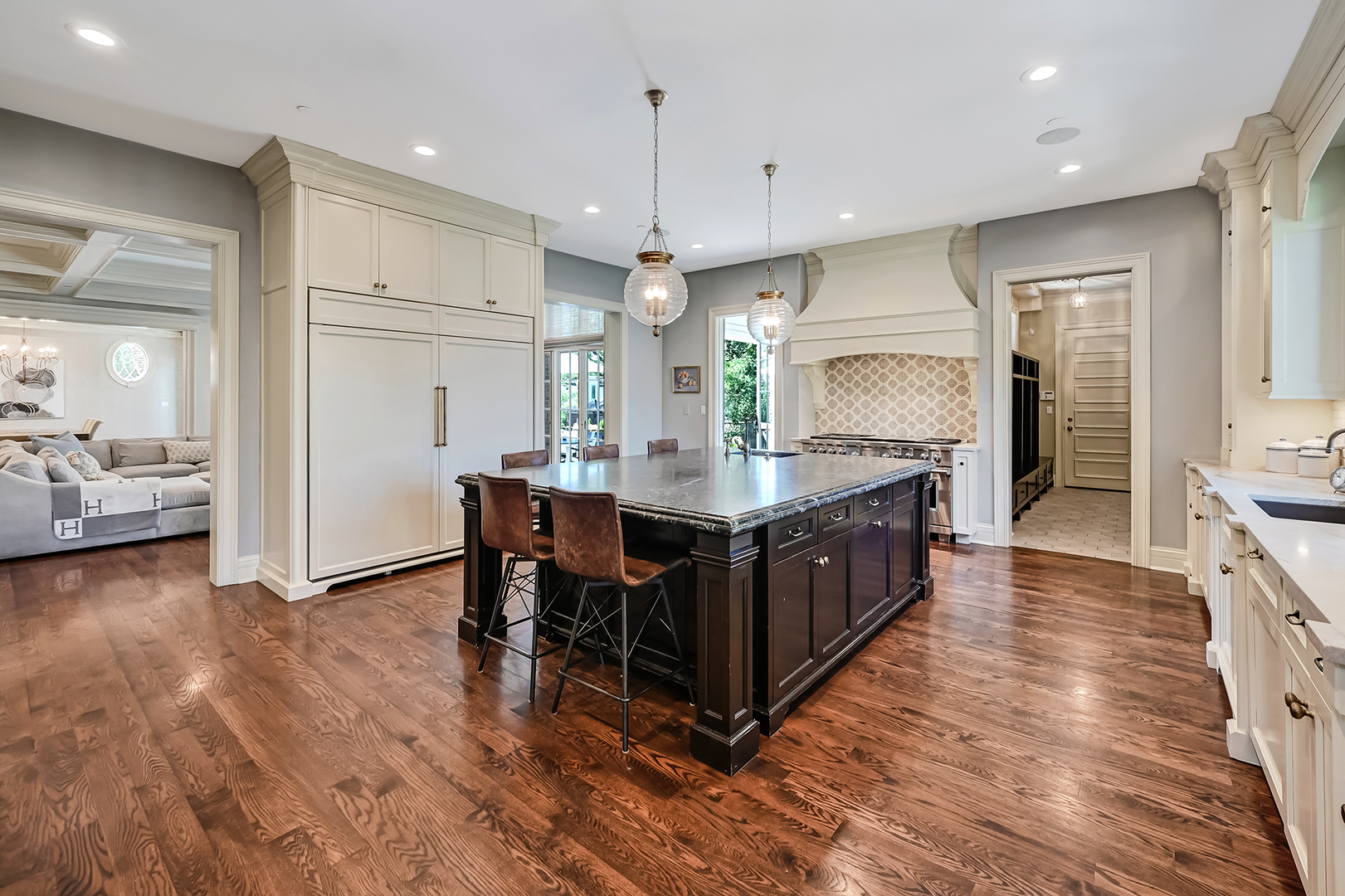 4736 Grand Avenue Western Springs, IL 60558 - Photo 17 of 69 a kitchen with kitchen island granite countertop a sink cabinets and wooden floor