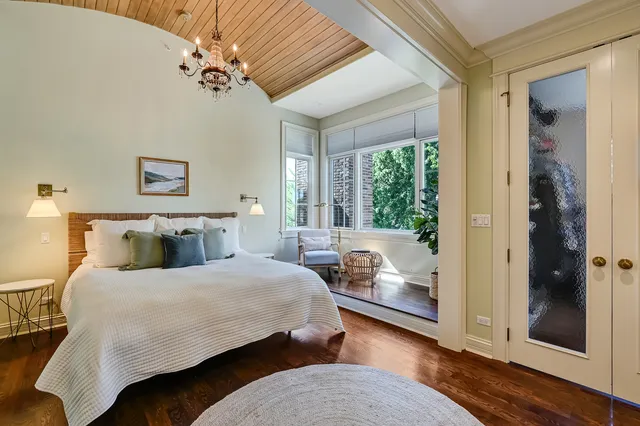 a bed sitting in a bedroom next to a bathroom