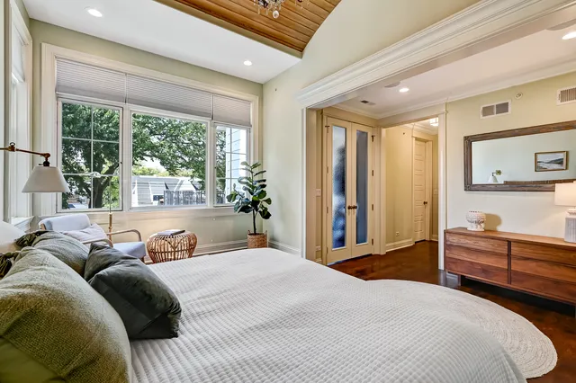 a bathroom with a sink a toilet a mirror and shower
