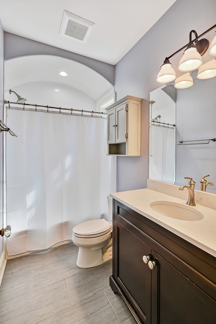 4736 Grand Avenue Western Springs, IL 60558 - Photo 41 of 69 a bathroom with a sink a toilet a mirror and shower