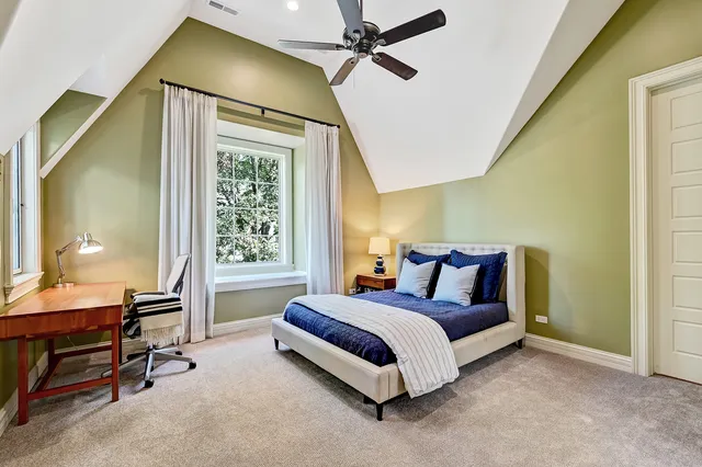 a view of a house with big yard and large trees
