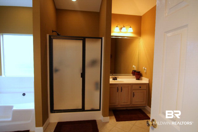 7263 Highpointe Place East Daphne, AL 36527 - Photo 18 of 22 This Master Bath features a separate shower and tub as well as his and hers vanities (hers has a makeup area)!