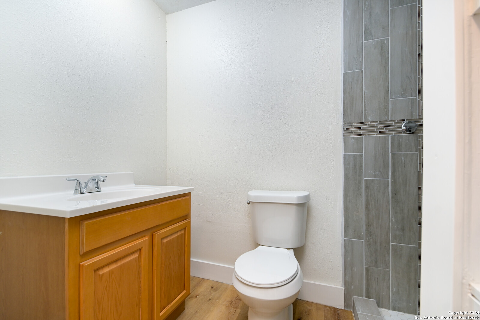 10527 Perrin Beitel Road, Unit A112 San Antonio, TX 78217 - Photo 13 of 16 a bathroom with a toilet a sink and mirror