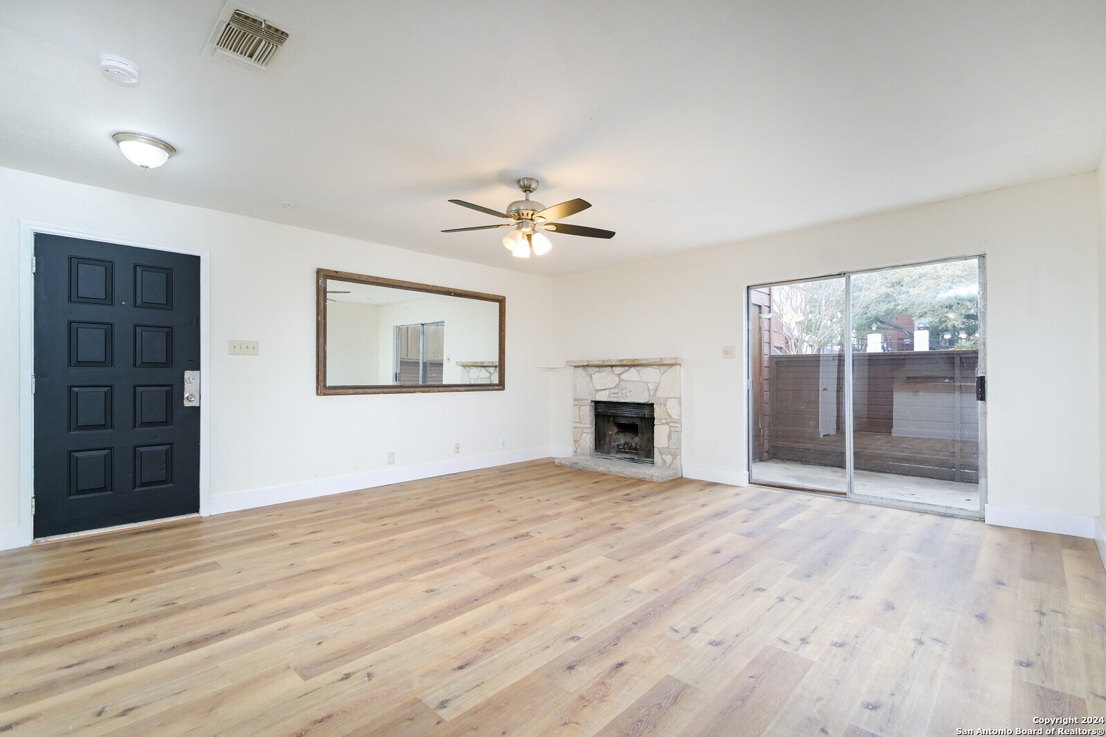 10527 Perrin Beitel Road, Unit A112 San Antonio, TX 78217 - Photo 4 of 16 a view of an empty room with a fireplace and a window