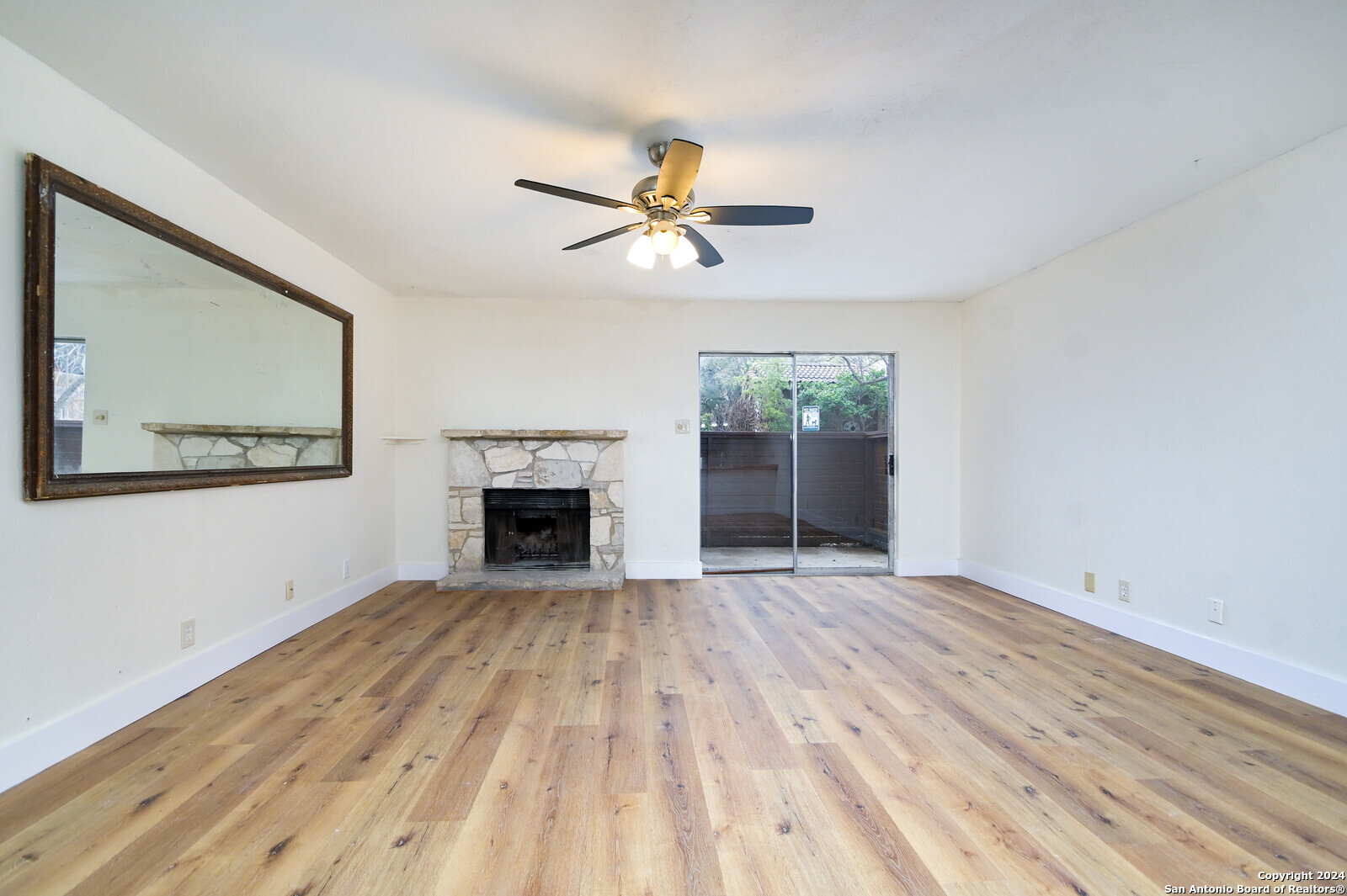 10527 Perrin Beitel Road, Unit A112 San Antonio, TX 78217 - Photo 5 of 16 a view of empty room with fireplace and fan