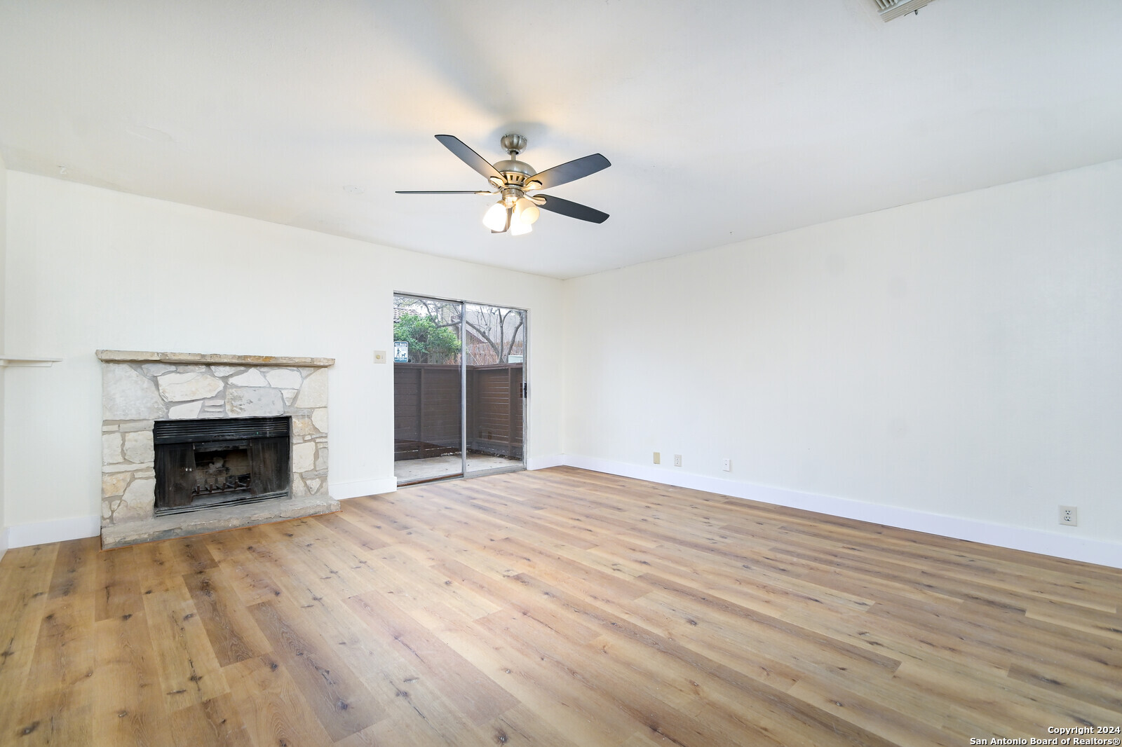 10527 Perrin Beitel Road, Unit A112 San Antonio, TX 78217 - Photo 6 of 16 a view of empty room with fireplace and fan