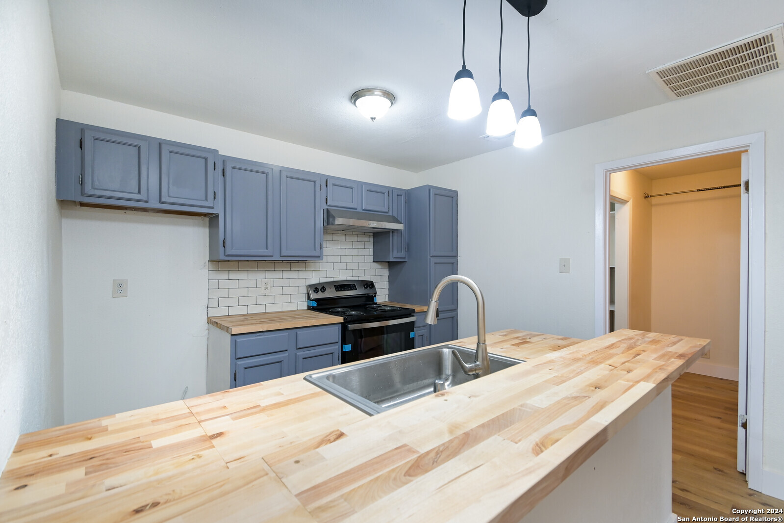 10527 Perrin Beitel Road, Unit A112 San Antonio, TX 78217 - Photo 8 of 16 a kitchen with stainless steel appliances kitchen island granite countertop a sink a stove a refrigerator and cabinets