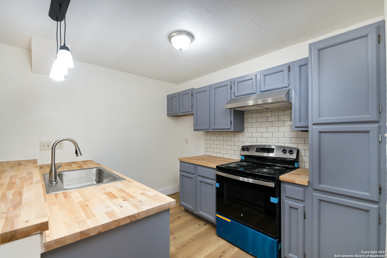 10527 Perrin Beitel Road, Unit A112 San Antonio, TX 78217 - Photo 9 of 16 a kitchen with kitchen island a counter space a sink and appliances