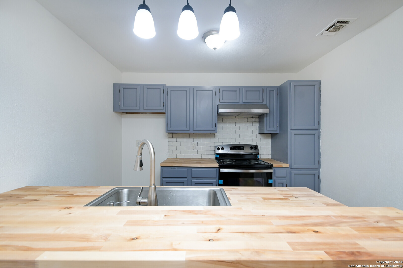 10527 Perrin Beitel Road, Unit A112 San Antonio, TX 78217 - Photo 10 of 16 a kitchen with kitchen island granite countertop a refrigerator a stove and a sink with granite countertops