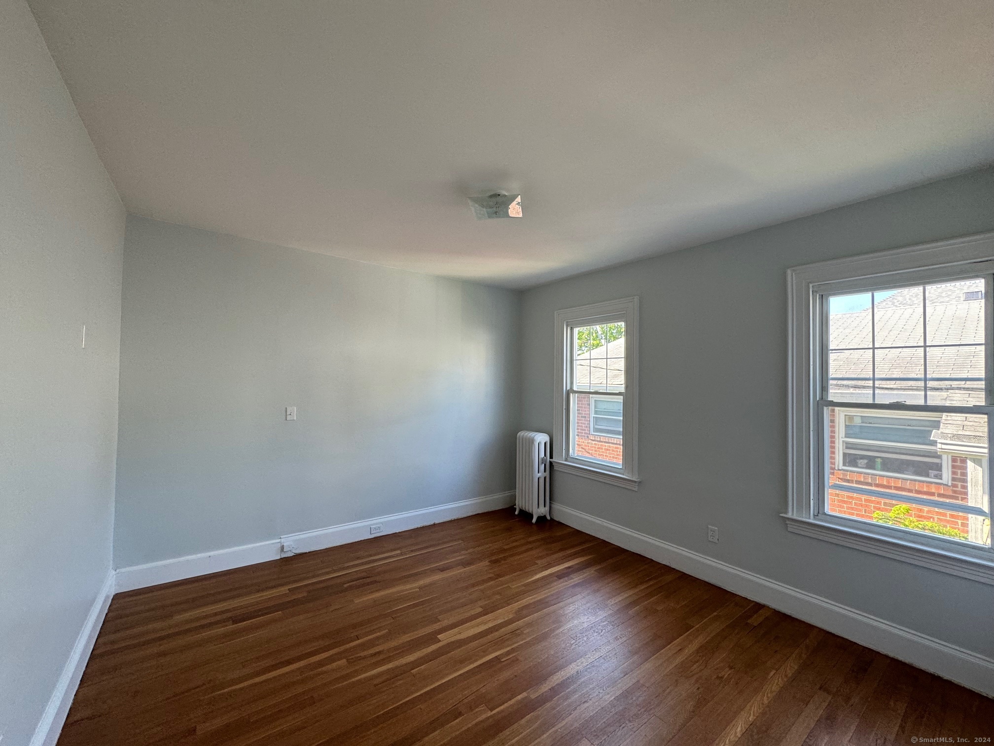 1253 Forest Road, Unit 2 New Haven, CT 06515 - Photo 24 of 30 an empty room with wooden floor and windows