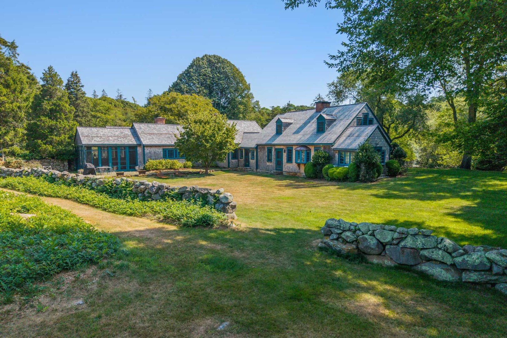 85 North Reservoir Road Vineyard Haven, MA 02568 - Photo 2 of 42 a view of a house with a big yard and large trees